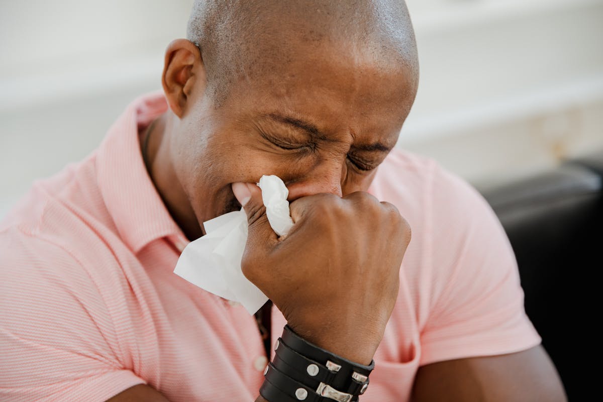 Close-Up Photo of Man Crying in Pink Shirt