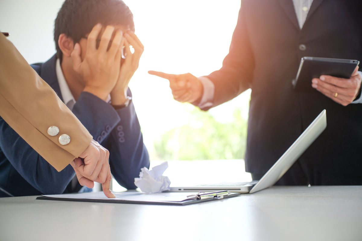 Angry boss  Bullying with an out of control boss shouting to a stressed employee. Anger issues and stress office bullies